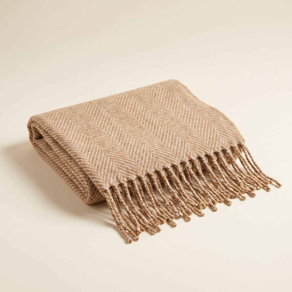 Herringbone Oversized Fringe Scarf in camel and oatmeal folded on an ivory background