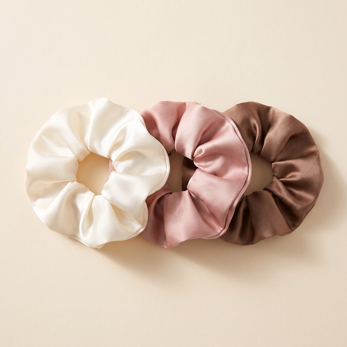 Oversized Satin Scrunchie Set of 3 in ivory, blush pink and mocha on an ivory background