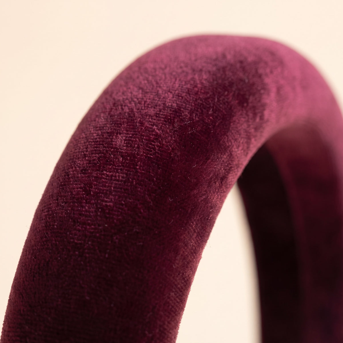 Close-up of the plush burgundy velvet pile on the padded headband